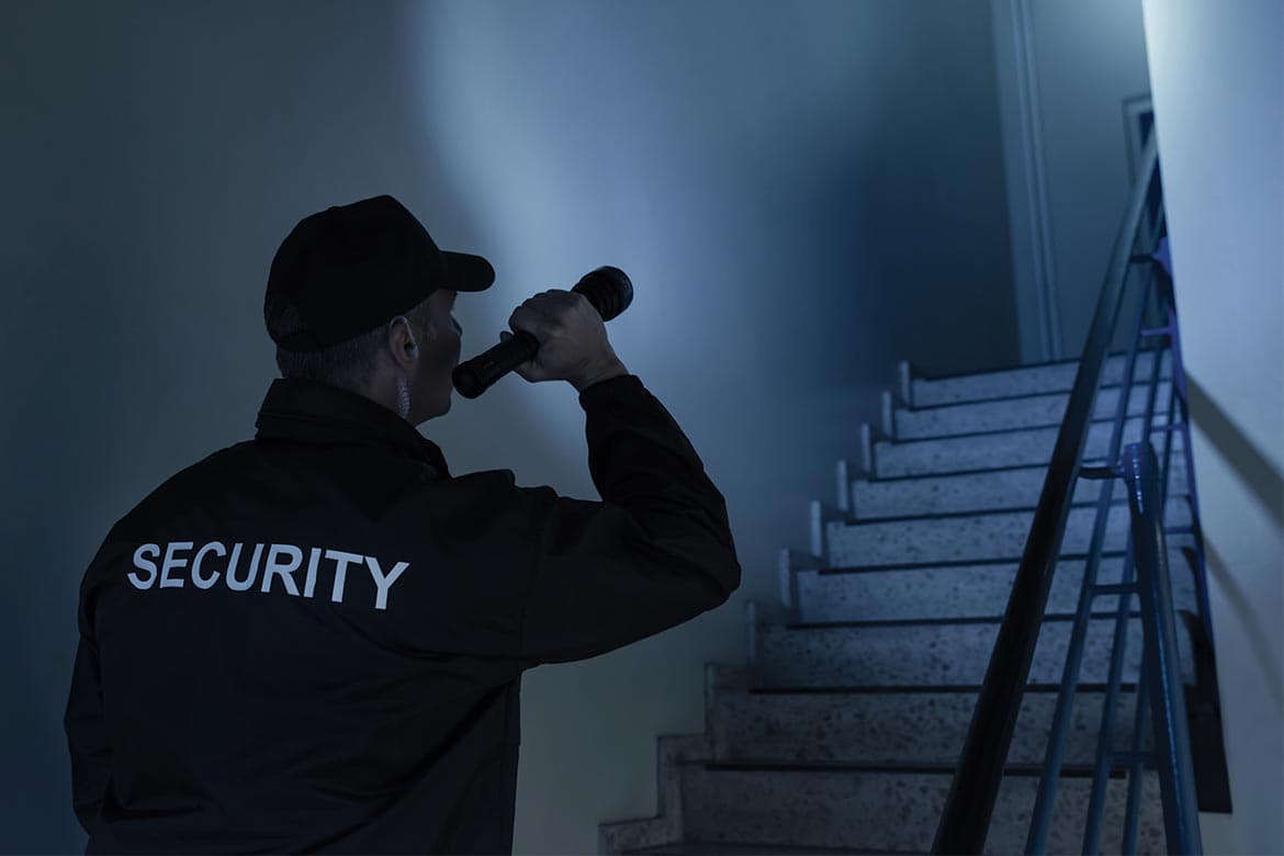 Metro Guards alarm response officer inspecting a building after an alarm activation