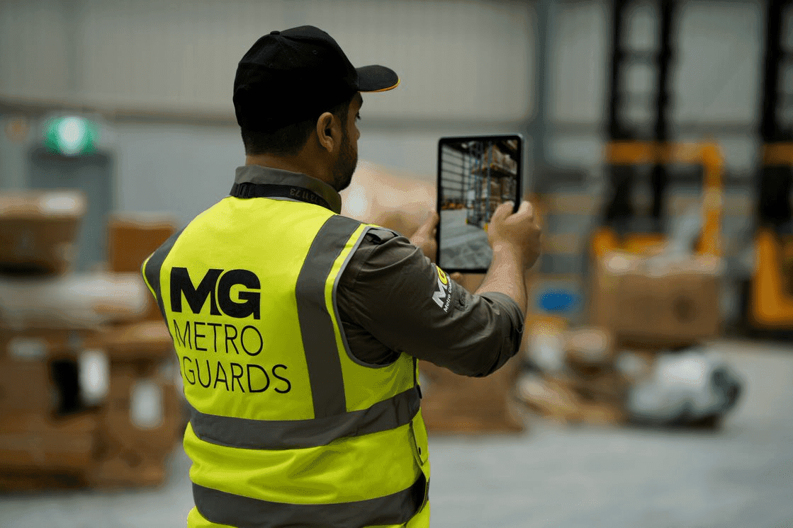 Metro Guards technician reviewing live CCTV footage on a tablet in Melbourne